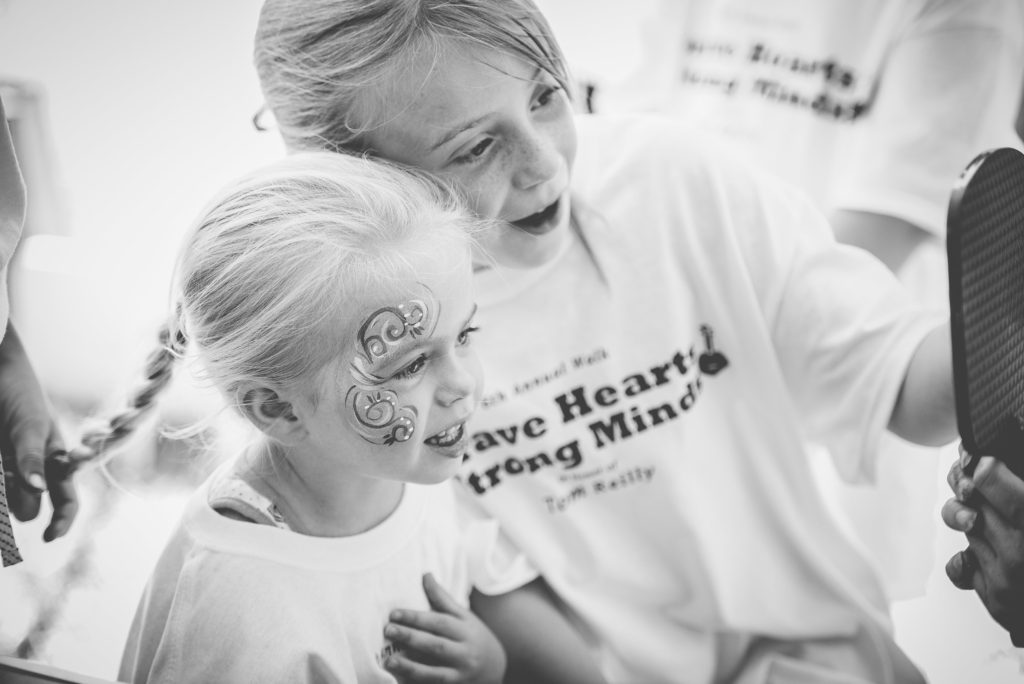 contact bhsm - two young girls admiring face paint